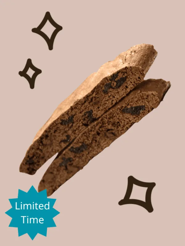 Close-up of two stacked Dee Dee's Dunkers biscotti sliced on a beige background highlighting the cherries inside